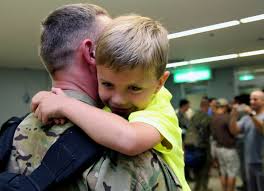 A child hugs his father